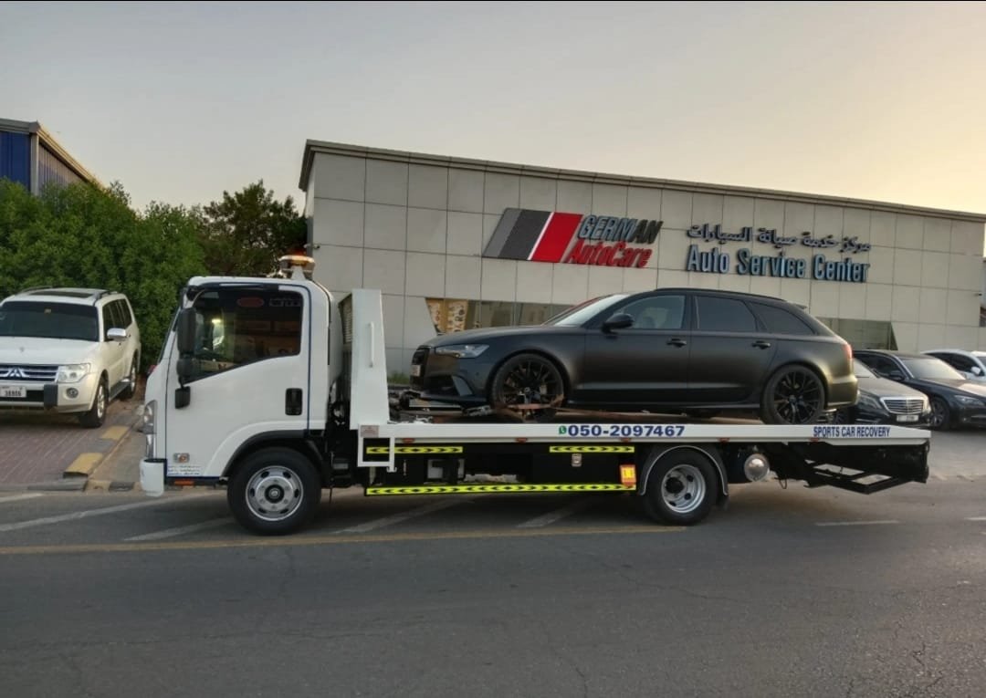 Flatbed towing Dubai — vehicle secured on flatbed