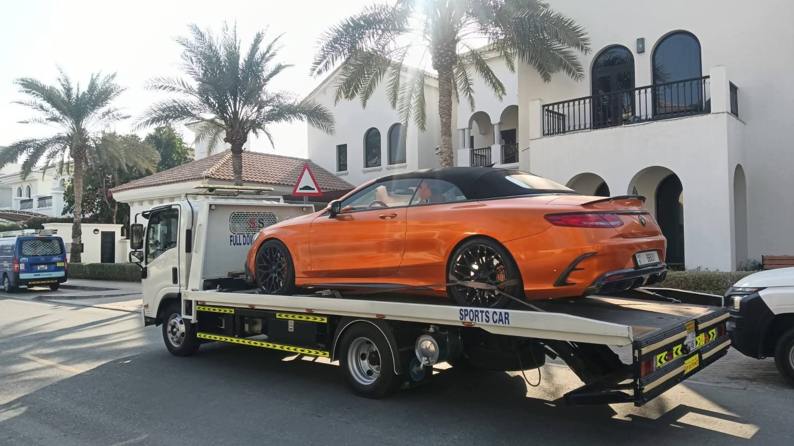 Luxury car recovery Dubai — Mercedes AMG convertible orange Palm Jumeirah