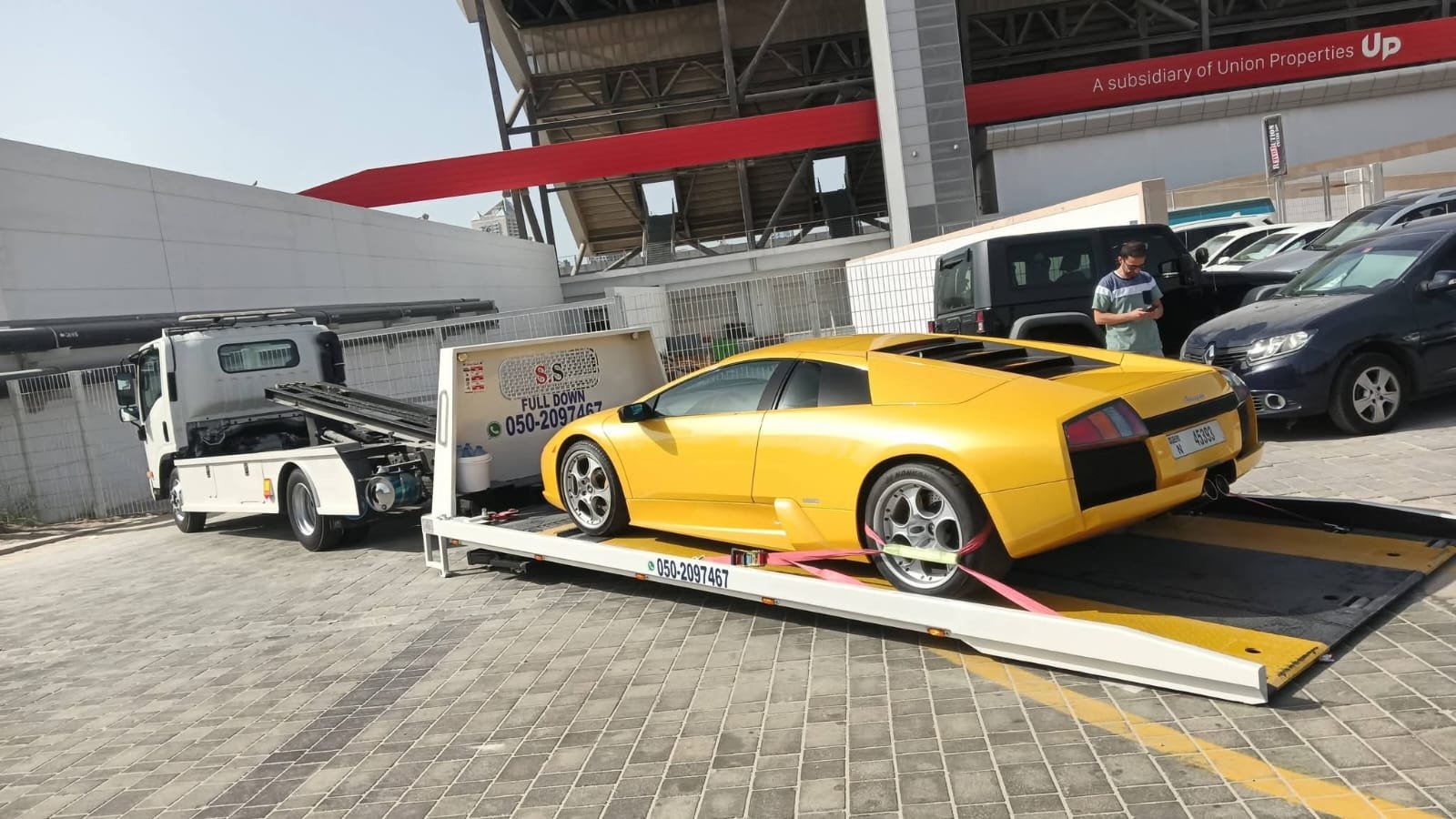 Sports car recovery Dubai — Lamborghini Murcielago yellow on flatbed